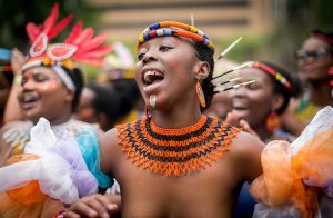 Women in their traditional outfits sing and dance in the streets during the Indoni SA Cultural Festival on October 7, 2017 in Durban.
 The Indoni festival, a three-day feast, showcases traditions of South African provinces and aims to demonstrate unity and the unique diversity of the country. / AFP PHOTO / RAJESH JANTILAL