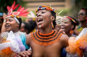 Women in their traditional outfits sing and dance in the streets during the Indoni SA Cultural Festival on October 7, 2017 in Durban.
 The Indoni festival, a three-day feast, showcases traditions of South African provinces and aims to demonstrate unity and the unique diversity of the country. / AFP PHOTO / RAJESH JANTILAL